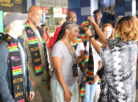 Dr. Spirit receives a welcome sash at KIA