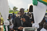 Vice President Amissah-Arthur cutting the ribbon to present the bus to the school authorities.