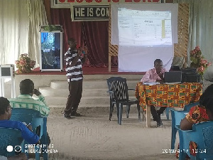 Mr Roxy Asamoa, the Municipal Examination Officer making a presentation