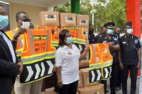 Deputy MTTD boss (second right) receives a donation of vests to the Department