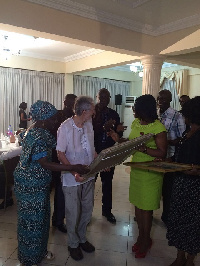 Rev. Peter John (middle) Moss receives citation of honour