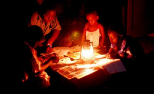 Students reading with lantern due to dumsor