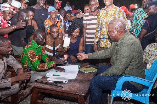 File photo: Former President John Mahama registers for the new NDC membership form