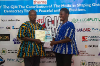 Moses Apiah receiving a citation on the awards night