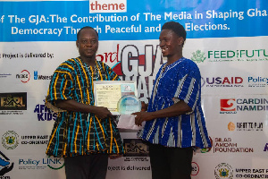 Moses Apiah receiving a citation on the awards night