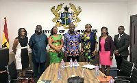 UNDP Ghana Rep, Angelina Lusigi (L) in a group photo with Information Minister and some officials