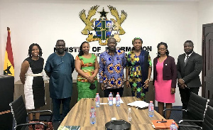 UNDP Ghana Rep, Angelina Lusigi (L) in a group photo with Information Minister and some officials