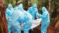 Public health officials bury a person who died of Covid-19 at Antuanthenge village in Meru County