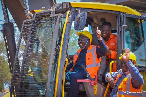 Dr Mahamudu Bawumia in the midst of some workers