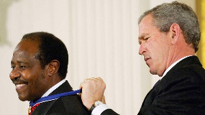 Former US President George W. Bush presents the Presidential Medal of Freedom to Paul Rusesabagina