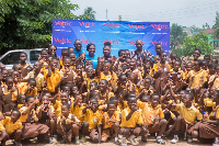 Some officials of Voltic Ghana in a group photograph with some of the pupils