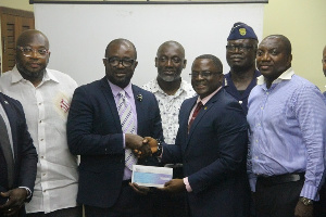 GOC President, Ben Nunoo Mensah presenting the money to GFA boss Kurt Okraku