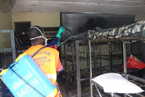 Zoomlion fumigation team disinfecting a dormitory in the school