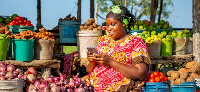 A trader using GSMA mobile money