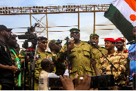 Members of a military council that staged a coup in Niger attend a rally at a stadium in Niamey