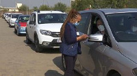 A nurse speaks to a man waiting in line for a Covid-19 jab at Kempton Park, Johannesburg