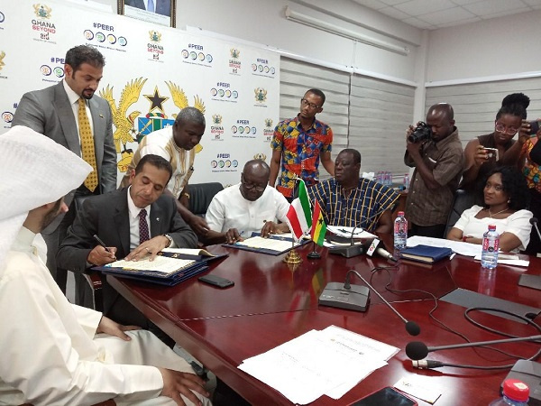 Finance Minister, Ken Ofori-Atta signing the agreement with the reps from Kuwait