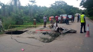 Some residents inspecting the damages on the road