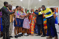 Tetrete Okuamuah Sekyim II presenting the trophy to the winning school