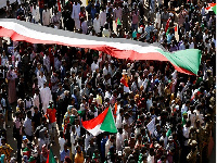 People celebrate first anniversary of the uprising that toppled long-time ruler Omar al-Bashir