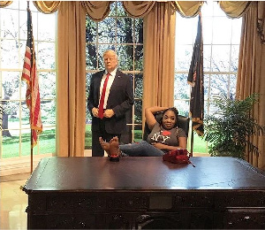 Moesha Boduong poses with the wax of Trump