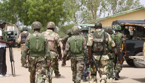 The uniformed military men were guarding illegal Chinese Miners