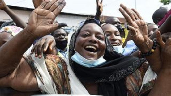 Supporters wave to incumbent Benin President Patrice Talon on his arrival to vote at the Zongo Ehuzu