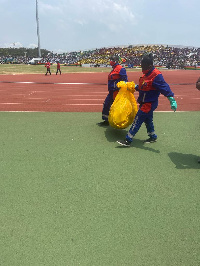 Some workers cleaning  the Cape Coast Sports Stadium