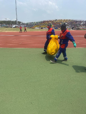 Some workers cleaning  the Cape Coast Sports Stadium