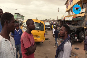 Some drivers having a group conversation along the street at Dome-Crossing