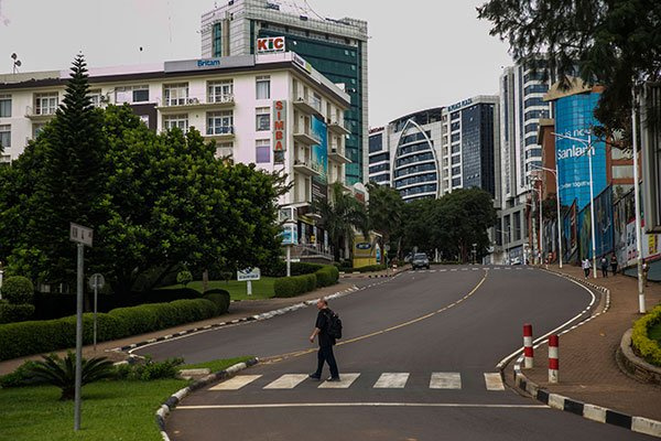 A pedestrian crosses a road in downtown Kigali, Rwanda, PHOTO | CYRIL NDEGEYA