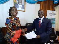 Patricia Safo presenting the petition to the Deputy Fisheries Minister, Kingsley Ato Cudjoe