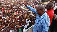 President John Mahama waving at a crowd during one of his campaign tour