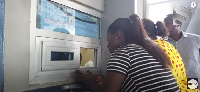 Cassie buying fish at the Tema harbour