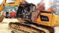 A photo of an excavator set on fire