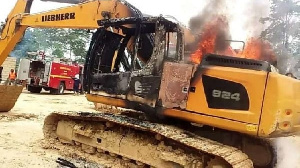 A photo of an excavator set on fire