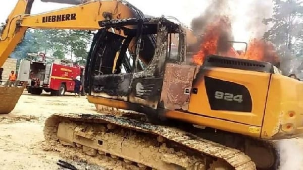 A photo of an excavator set on fire