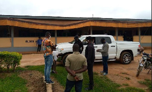 Tanko Mohammed, the victim, being spoken to by a police officer