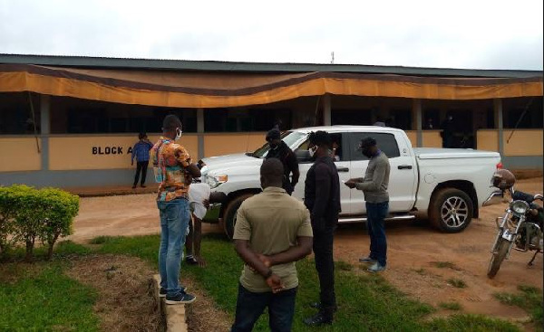 Tanko Mohammed, the victim, being spoken to by a police officer