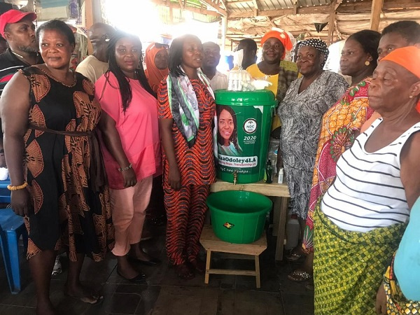 Hon. Odoley in a photo pose with some NDC executives and executives of La market women