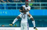 Frank Acheampong celebrating the team's win with Mikel Obi