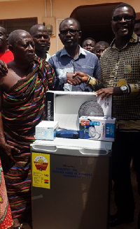 Mr. Okyere (right) presenting the gift to Mr. Djimatey looking on is Chief of Oyoko