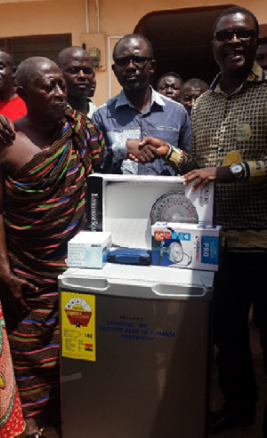 Mr. Okyere (right) presenting the gift to Mr. Djimatey looking on is Chief of Oyoko