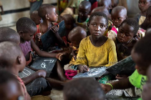 Children seated on the floor of a room