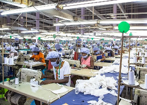 Workers assemble personal protective equipment for frontline health staff at a factory in Accra comm