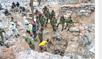 Zambian army special forces officers follow the rescue operation of miners