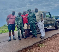 Some of the men in a pose with some soldiers in one the countries they got to