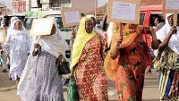 Some of the women with placards inscribed with words of support for Yababa