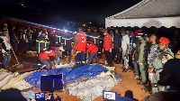 Rescuers prepare to carry bodies of the deceased from a landslide in Cameroon