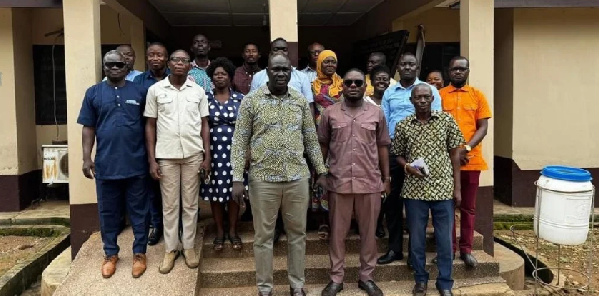 Mr Daniel Machator (middle) with staff of Nkwanta - South Municipal Assembly